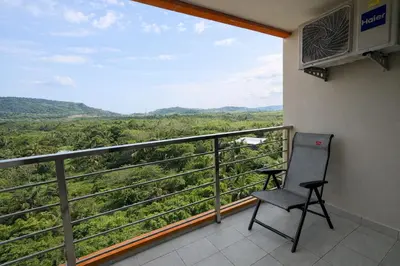 a chair sitting on a balcony with a view at MaiKhao Sunrise Sight Space in Ban Mai Salae