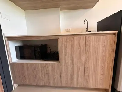 a cupboard with a microwave in a room at MaiKhao Sunrise Sight Space in Ban Mai Salae