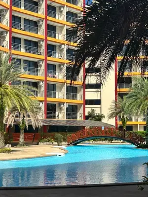 a building with a bridge in front of a swimming pool at MaiKhao Sunrise Sight Space in Ban Mai Salae