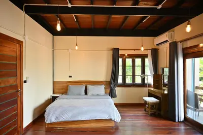 a bedroom with a bed and a desk in it at The Moonlight Guesthouse in Patong Beach