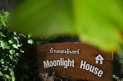 a wooden sign with the words moonlight house at The Moonlight Guesthouse in Patong Beach