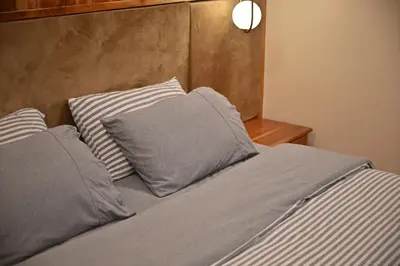 a bed with two pillows on top of it at The Moonlight Guesthouse in Patong Beach