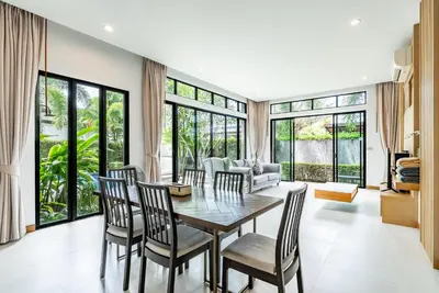a dining room with a table and chairs at Tanode Villa 511 by Villacarte in Bang Tao Beach