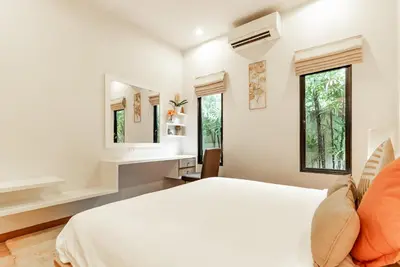 a white bedroom with a bed and a mirror at Tanode Villa 511 by Villacarte in Bang Tao Beach