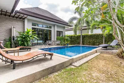 a swimming pool in the backyard of a house at Tanode Villa 511 by Villacarte in Bang Tao Beach
