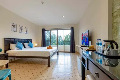 a bedroom with a bed and a large window at Club22 Kamala Suites, Kamala Beach in Kamala Beach