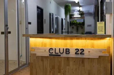 a sign that reads club on a wooden counter at Club22 Kamala Suites, Kamala Beach in Kamala Beach