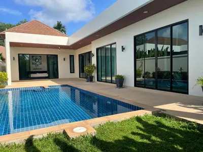 a swimming pool in front of a house at Andaman 3br Private Pool Villa in Rawai Beach