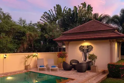 an elephant statue next to a house with a pool at Garden bungalows 4br with private pool in Rawai Beach