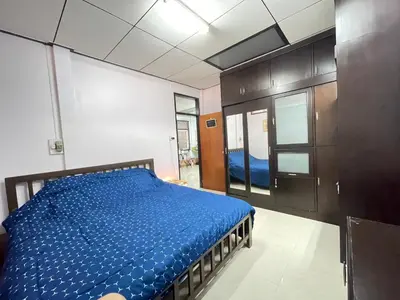 a bedroom with a bed with a blue comforter at Lotus House in Ban Lo Long