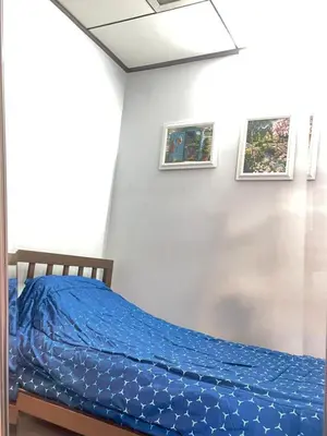 a bedroom with a bed with a blue comforter at Lotus House in Ban Lo Long
