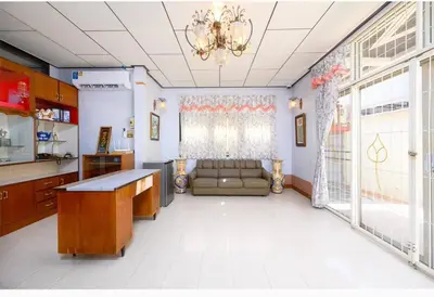 a living room with a couch and a chandelier at Lotus House in Ban Lo Long