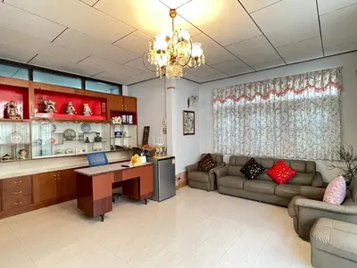 a large living room with a couch and a desk at Lotus House in Ban Lo Long