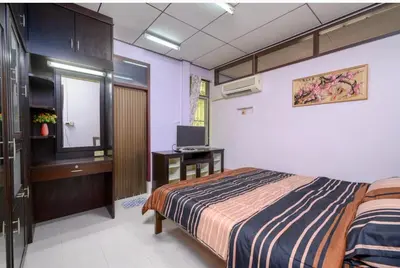 a bedroom with a bed and a television in it at Lotus House in Ban Lo Long