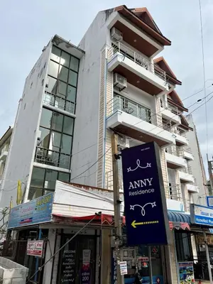 a building with a sign in front of it at AINNY Residence in Patong Beach