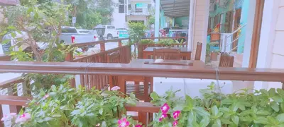 a porch with wooden railings and plants on a house at AINNY Residence in Patong Beach