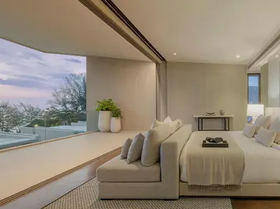 a bedroom with a bed and a couch and a window at Veyla Natai Residences - Luxury Pool Villa in Khok Kloi