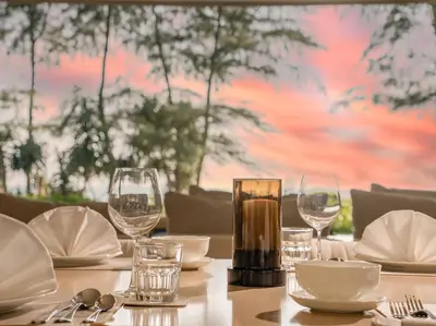 a table with wine glasses and plates on it at Veyla Natai Residences - Luxury Pool Villa in Khok Kloi