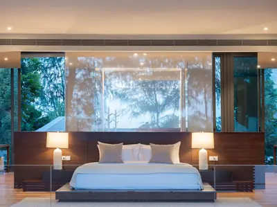 a bedroom with a large bed with two lamps at Veyla Natai Residences - Luxury Pool Villa in Khok Kloi