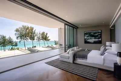 a bedroom with a large bed with a view of the ocean at Veyla Natai Residences - Luxury Pool Villa in Khok Kloi