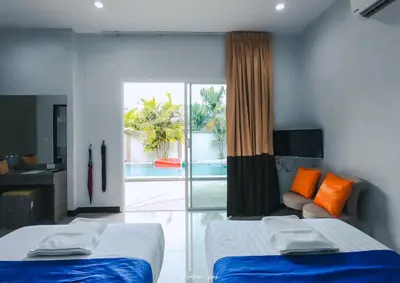 a bedroom with two beds and a view of a pool at Private Pool Villa at Nai Harn 2 bedroom in Rawai Beach