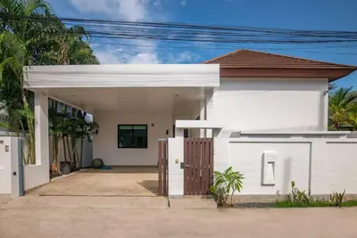 a white house with a gate in front of it at Oriental 3br private Pool Villa in Rawai Beach