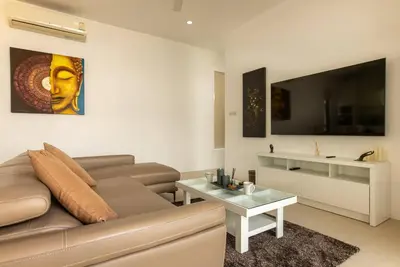 a living room with a couch and a table at Oriental 3br private Pool Villa in Rawai Beach