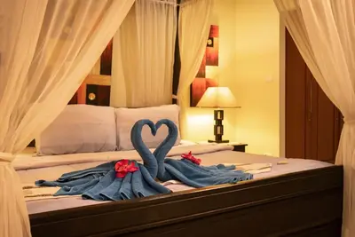 a bed with two swans made out of towels at Villa Rodentia 3br pool Villa in Rawai Beach