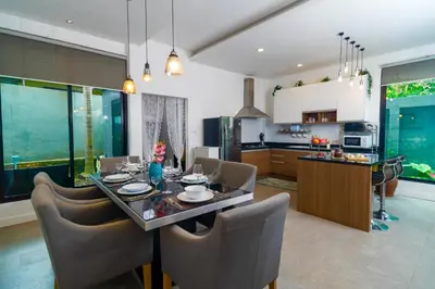 a kitchen and dining room with a table and chairs at Villa Charming - Lovely 2 bedrooms house with pool in Rawai Beach