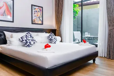 a bedroom with a large white bed with pillows at Villa Charming - Lovely 2 bedrooms house with pool in Rawai Beach