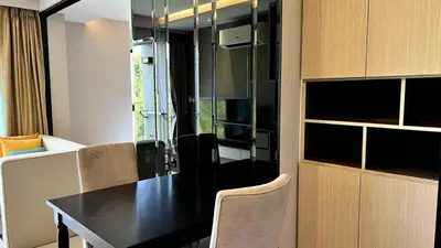 a living room with a black table and a couch at Mida Grande Apartment with Rooftop Pool near Surin Beach in Surin Beach
