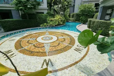 a mosaic clock in the middle of a pool at F1 The Title Residencies Naiyang Phuket 1 Floor 1 Bdr in Nai Yang Beach