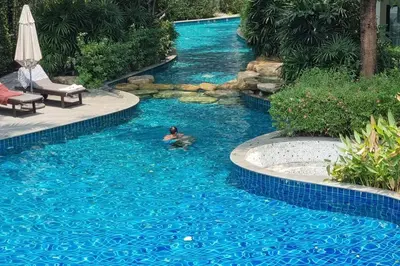 a person swimming in a swimming pool in a swimming pool at F1 The Title Residencies Naiyang Phuket 1 Floor 1 Bdr in Nai Yang Beach
