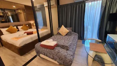 a bedroom with a bed and a chair and a mirror at F1 The Title Residencies Naiyang Phuket 1 Floor 1 Bdr in Nai Yang Beach