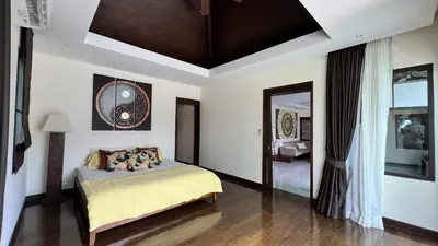 a bedroom with a bed and a mirror at Plunge Tropic Pool Villa near Nai Harn Beach in Rawai Beach