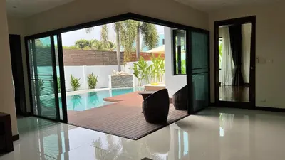 a house with a pool and a patio with chairs at Plunge Tropic Pool Villa near Nai Harn Beach in Rawai Beach