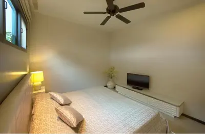 a bedroom with a bed with a ceiling fan and a tv at Вилла с бассейном на Най Харн, 3 спальни G7 in Rawai Beach