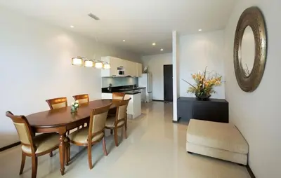 a dining room and kitchen with a table and chairs at Вилла с бассейном на Най Харн, 3 спальни G7 in Rawai Beach