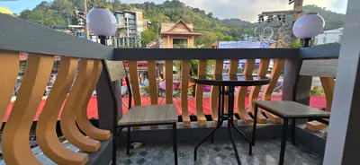 a balcony with two chairs and a table on a balcony at Taxim Boutique Hotel in Patong Beach