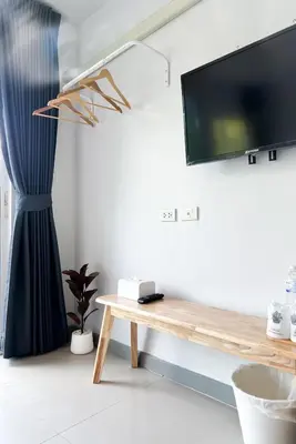 a living room with a tv and a wooden table at BAOBAB in Patong Beach