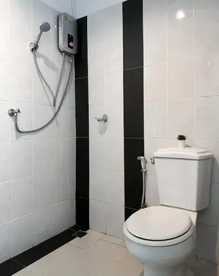 a bathroom with a toilet and a shower at BAOBAB in Patong Beach