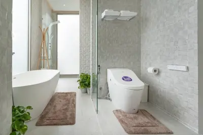 a bathroom with a toilet and a tub and a sink at The Residence by Andaman Villa in Phuket Town