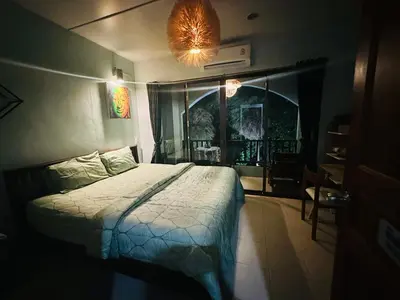 a bedroom with a bed in a room with a window at MILD ROOM SEA VIEW ROOM FOR RENT in Phi Phi Don