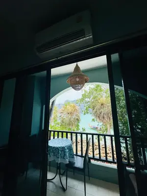 a balcony with a table and a view of the ocean at MILD ROOM SEA VIEW ROOM FOR RENT in Phi Phi Don