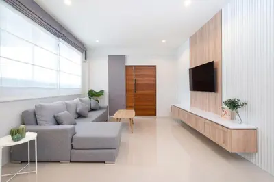 a living room with a couch and a tv at 2BR Homey townhome 350M walk to Kata Beach Fully equipped in Kata Beach