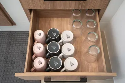 a wooden box with glasses and other items in it at 2BR Homey townhome 350M walk to Kata Beach Fully equipped in Kata Beach