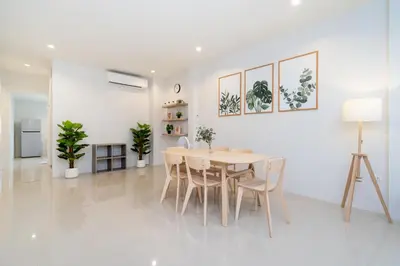 a white dining room with a table and chairs at 2BR Homey townhome 350M walk to Kata Beach Fully equipped in Kata Beach