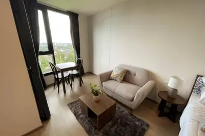 a living room with a couch and a table at The Base Central - Luxury Resort-Style Comfort in Ban Rangeng