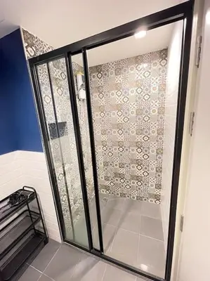 a shower with a glass door in a bathroom at The Base Central - Luxury Resort-Style Comfort in Ban Rangeng