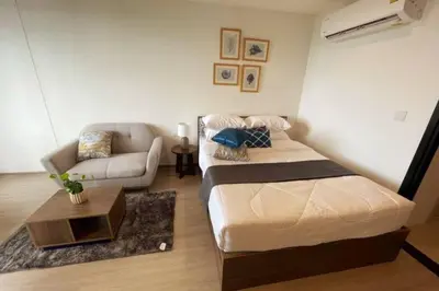 a living room with a bed and a couch at The Base Central - Luxury Resort-Style Comfort in Ban Rangeng